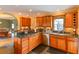 Gourmet kitchen with granite countertops, stainless steel appliances, and custom wood cabinetry at 215 Willowick Ave, Temple Terrace, FL 33617