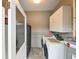 Laundry room with washer, dryer, storage cabinets, and tiled floor at 215 Willowick Ave, Temple Terrace, FL 33617
