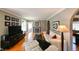 Inviting living room with hardwood floors, fireplace, white furniture, and black media center at 215 Willowick Ave, Temple Terrace, FL 33617