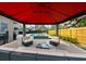 Backyard seating area underneath a pergola, overlooking the pool and backyard at 215 Willowick Ave, Temple Terrace, FL 33617