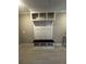 Mudroom featuring a white storage cabinet with a wooden bench, and light colored tile floors at 2359 Lanier Rd, Zephyrhills, FL 33541