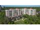 Aerial view of condos showcasing manicured landscaping, parking, and red tile roofs at 2405 S Ardson Pl # 303A, Tampa, FL 33629