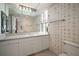 Bathroom with a long countertop, bird wallpaper and modern lighting at 2405 S Ardson Pl # 303A, Tampa, FL 33629