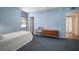 Bedroom with blue walls and carpet, chest, and bright window at 2405 S Ardson Pl # 303A, Tampa, FL 33629