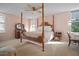 Spacious bedroom with a four-poster bed, ceiling fan, and large windows at 2405 S Ardson Pl # 303A, Tampa, FL 33629