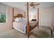 Bedroom featuring a four-poster bed, large windows, and double door closet at 2405 S Ardson Pl # 303A, Tampa, FL 33629