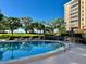 Community pool with waterfront views and lounge chairs for relaxing in the sun at 2405 S Ardson Pl # 303A, Tampa, FL 33629
