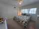 Bright bedroom featuring two twin beds, a ceiling fan, and a closet for storage at 2431 Franciscan Dr # 45, Clearwater, FL 33763