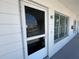 Exterior entrance featuring door, screen, windows, and the unit number 45 at 2431 Franciscan Dr # 45, Clearwater, FL 33763