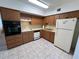 Functional kitchen with oak cabinets and essential white appliances at 2431 Franciscan Dr # 45, Clearwater, FL 33763