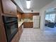 The kitchen features wood cabinets and access to the living area at 2431 Franciscan Dr # 45, Clearwater, FL 33763
