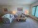 Inviting living room featuring carpet, comfortable seating and decorative lamps at 2431 Franciscan Dr # 45, Clearwater, FL 33763