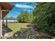 Lush backyard featuring partial view of the screened pool enclosure and plenty of room for outdoor enjoyment at 2482 Whitewood Ave, Spring Hill, FL 34609