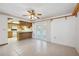 Open space leading to kitchen with a breakfast bar and view of the pool through sliding doors at 2482 Whitewood Ave, Spring Hill, FL 34609