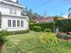 Lush backyard with a geometric dome climber, privacy hedges, and a glimpse of the home's exterior at 2514 W Morrison Ave, Tampa, FL 33629