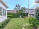 Lush backyard featuring green lawn, privacy hedges, and a fun playground structure, perfect for outdoor enjoyment at 2514 W Morrison Ave, Tampa, FL 33629