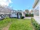 Backyard with a charming detached garage covered with climbing vines and lush green grass at 2514 W Morrison Ave, Tampa, FL 33629
