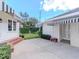 Backyard space featuring a small lawn area with a concrete pad between the house and garage at 2514 W Morrison Ave, Tampa, FL 33629