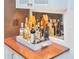 Close-up of a bar area featuring a wood countertop, mirrored backsplash and a variety of bottles at 2514 W Morrison Ave, Tampa, FL 33629