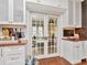 Stylish bar area with custom cabinets, mirrored backsplash, and convenient access through french doors at 2514 W Morrison Ave, Tampa, FL 33629