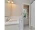 Bright bathroom featuring subway tile, white fixtures, and a window overlooking the greenery outside at 2514 W Morrison Ave, Tampa, FL 33629