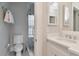 Bright bathroom featuring tiled floor, shower, toilet and white vanity at 2514 W Morrison Ave, Tampa, FL 33629