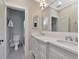 Elegant bathroom with double vanity sinks, modern fixtures, and a separate toilet room for added privacy at 2514 W Morrison Ave, Tampa, FL 33629