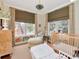 Comfortable bedroom with a cozy crib, windows for natural light, creating a warm and inviting space at 2514 W Morrison Ave, Tampa, FL 33629