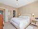 Cozy bedroom featuring neutral tones, carpet floors, a ceiling light, and two side tables at 2514 W Morrison Ave, Tampa, FL 33629