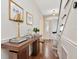 Elegant entryway boasts hardwood floors, a stylish console table with decor, and a staircase leading to upper levels at 2514 W Morrison Ave, Tampa, FL 33629