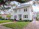 Stately two-story home with a brick walkway, green lawn, and classic architectural details at 2514 W Morrison Ave, Tampa, FL 33629