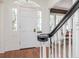 Welcoming foyer with hardwood floors, white wainscoting, and natural light from the front door at 2514 W Morrison Ave, Tampa, FL 33629