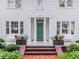 A close up of the front of the home showcasing the entry door, columns, and landscaping at 2514 W Morrison Ave, Tampa, FL 33629