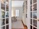 Home office space with built-in shelving and storage, as seen through glass paneled doors at 2514 W Morrison Ave, Tampa, FL 33629