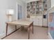 Bright home office featuring a built-in bookcase, a desk and a comfortable seating area at 2514 W Morrison Ave, Tampa, FL 33629