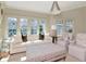 Bright living room boasts large windows, a comfortable white couch with plush pillows, and stylish striped armchairs at 2514 W Morrison Ave, Tampa, FL 33629