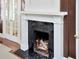 Living room fireplace with black marble surround and decorative mantle, enhancing the home's interior at 2514 W Morrison Ave, Tampa, FL 33629