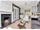 Elegant living room featuring a fireplace, built-in cabinets, and comfortable seating at 2514 W Morrison Ave, Tampa, FL 33629