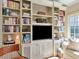 Cozy living room featuring a large built-in bookshelf with TV at 2514 W Morrison Ave, Tampa, FL 33629