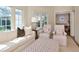 Sun-drenched living room offers comfortable seating, neutral decor, and a view to the outdoors through large windows at 2514 W Morrison Ave, Tampa, FL 33629
