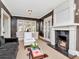 Inviting living room with a fireplace, classic chairs, and natural light from large windows at 2514 W Morrison Ave, Tampa, FL 33629