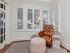 Comfortable sitting area with a leather chair, ottoman, natural lighting, and wood floors at 2514 W Morrison Ave, Tampa, FL 33629