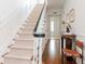 Elegant staircase with carpet runner, white banisters, and dark wood railing in the foyer at 2514 W Morrison Ave, Tampa, FL 33629