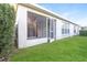 Back porch with screen and door and a well-kept lawn at 29636 Tee Shot Dr, San Antonio, FL 33576
