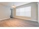 Bedroom with light laminate floors, white trim, a large window, and neutral paint at 29636 Tee Shot Dr, San Antonio, FL 33576