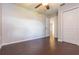 Cozy bedroom with dark floors, an open doorway, and a double-door closet at 29636 Tee Shot Dr, San Antonio, FL 33576