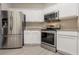 Modern kitchen equipped with stainless steel appliances and bright white cabinets at 29636 Tee Shot Dr, San Antonio, FL 33576