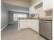 Well-lit kitchen showcasing stainless steel appliances, white cabinets, and a breakfast bar at 29636 Tee Shot Dr, San Antonio, FL 33576