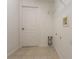 The laundry room has neutral tile flooring, white walls and trim, a door, and laundry connections at 29636 Tee Shot Dr, San Antonio, FL 33576