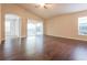 Bright living room featuring vaulted ceilings, dark hardwood floors, and a sliding glass door at 29636 Tee Shot Dr, San Antonio, FL 33576
